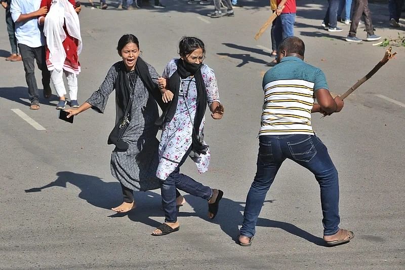 An activist of Bangladesh Chhatra League assaults two students, who join  the quota reform movement, on Dhaka University campus on 15 July 2024.